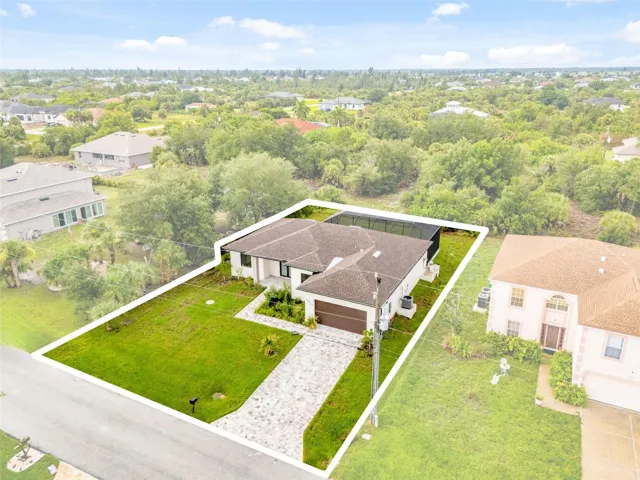 Green Belt Surrounds Home with Paver Driveway