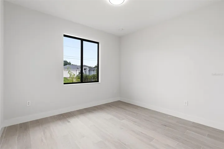 Bedroom 4 Features Natural Light & Porcelain Plank Tile Flooring