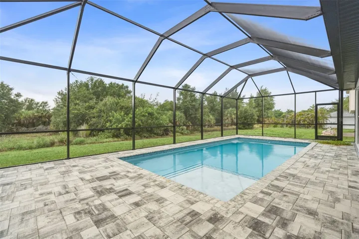 Screen Pool Area with Paver Deck and Peaceful Greenbelt Views