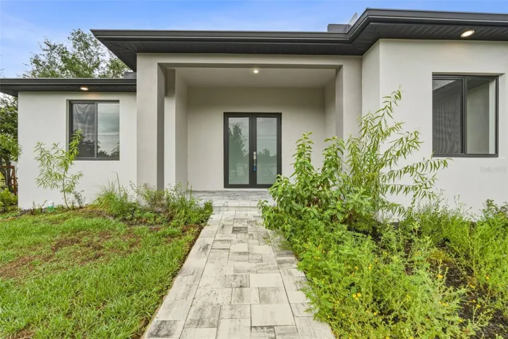 Paver Walkway Leads to Covered Porch and Double Frosted Glass Front Door