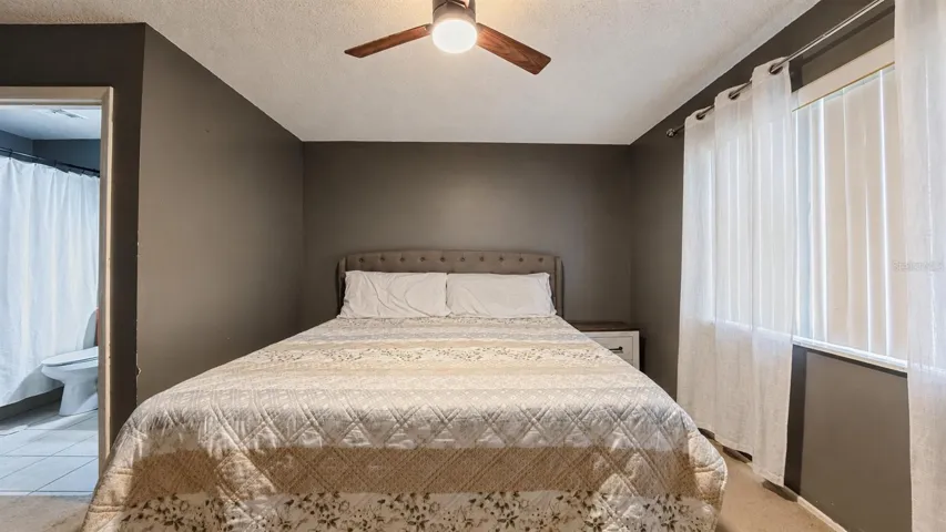 Primary bedroom with ceiling fan