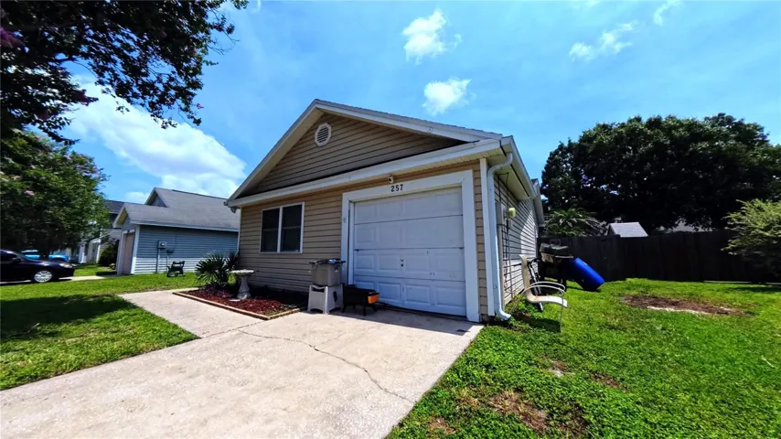 Front elevation showing covered entry and concrete driveway