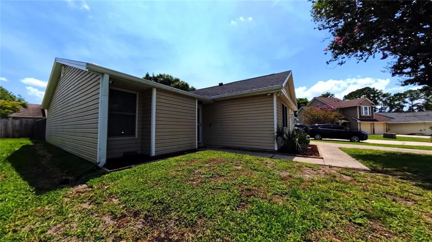 Front exterior, close view of entry door and garage
