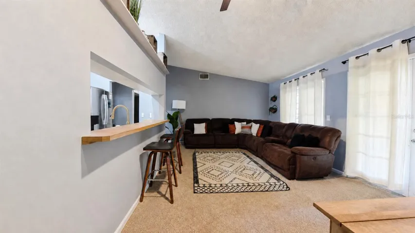 Breakfast bar pass-through between living area and kitchen