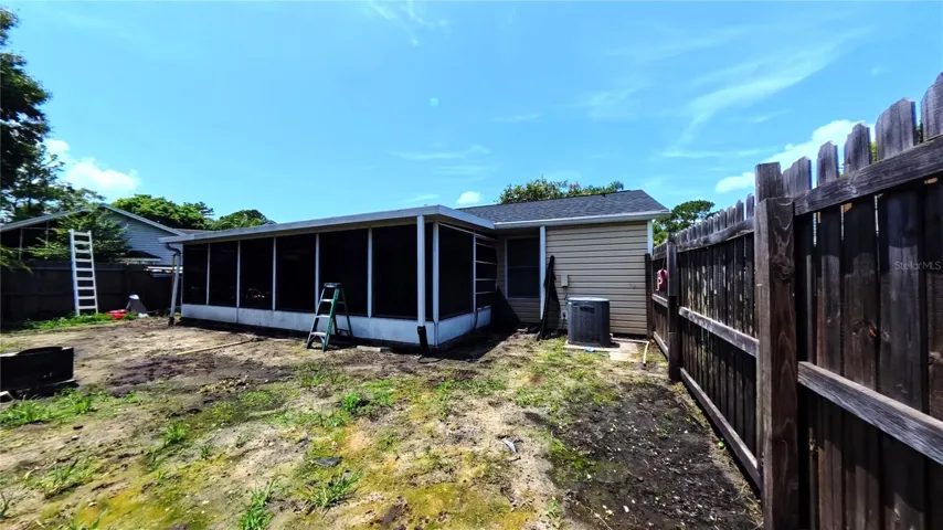 Rear exterior showing HVAC unit and fencing