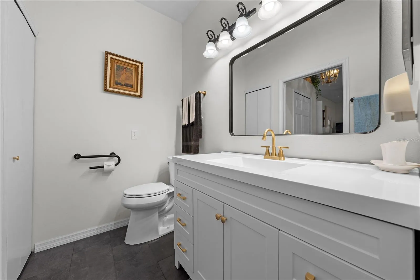 Primary bathroom with updated cabinets and vanity.