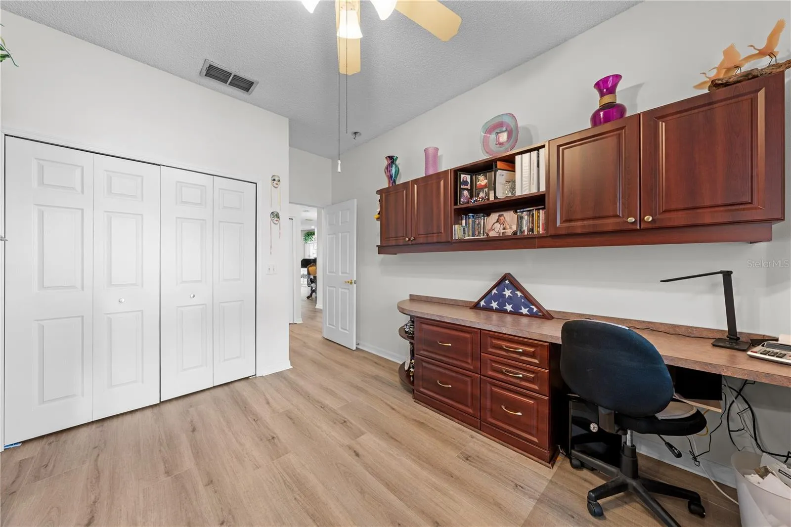 Bedroom 2 that has a murphy bed and built in cabinets and desk.