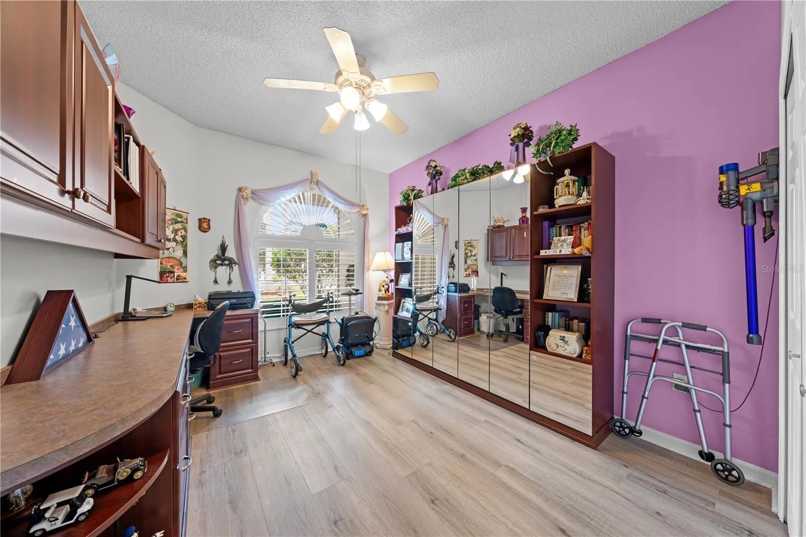 Bedroom 2 with built in cabinets and a murphy bed for smart spaces.