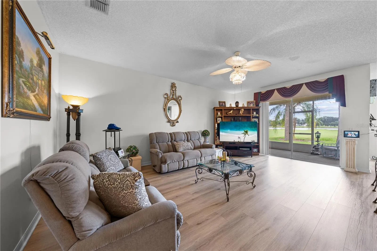 Living Room with view of the screened lanai and golf course.