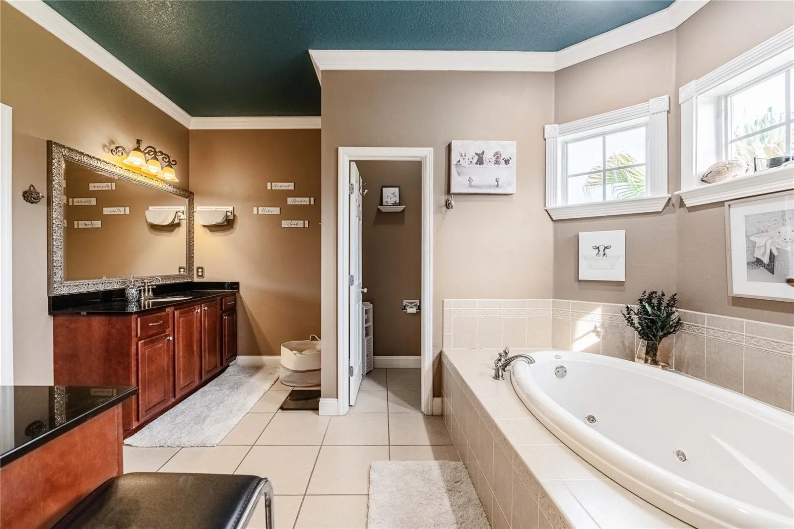 Primary bathroom with dual sinks and vanities
