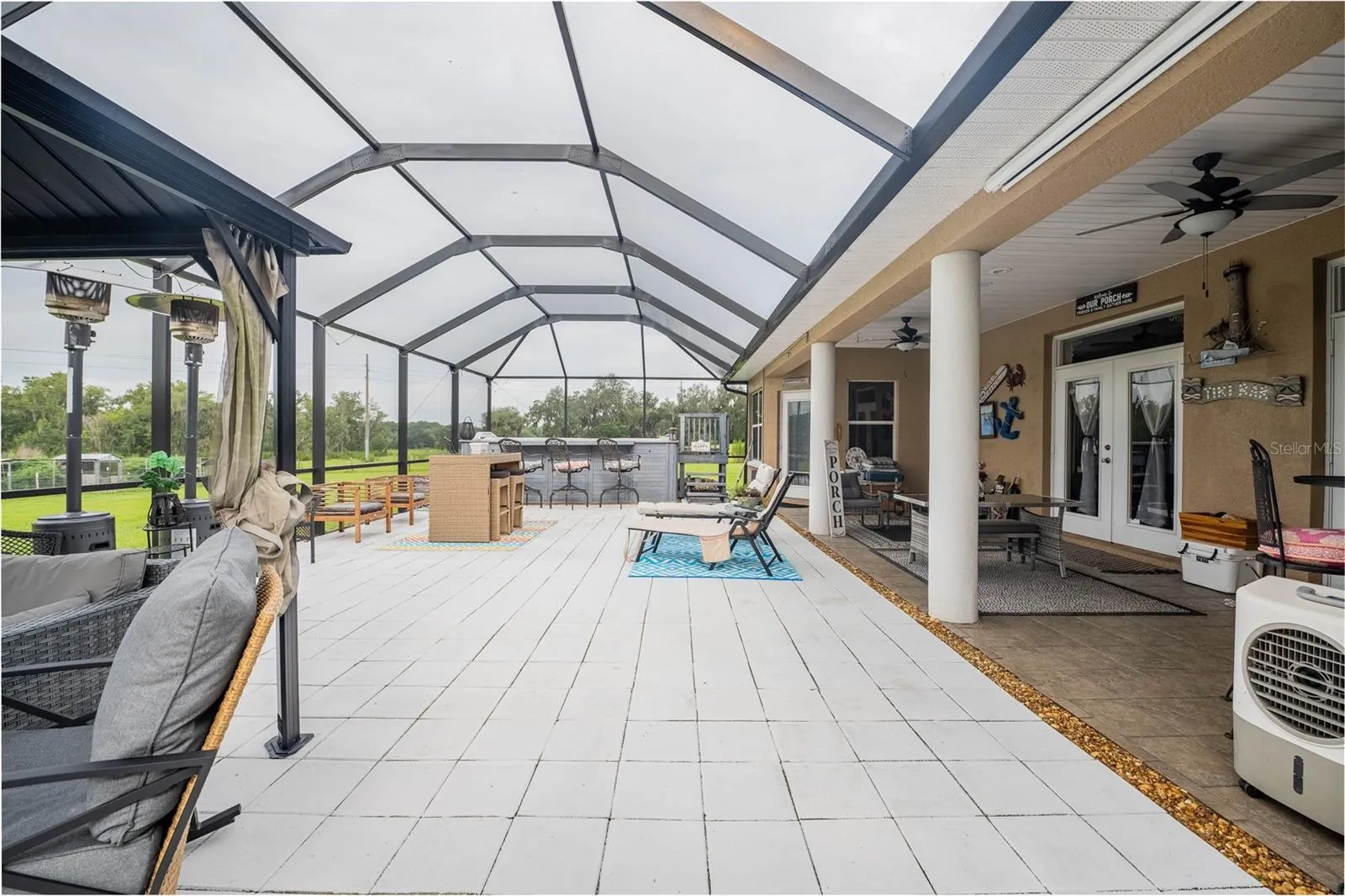 Spacious Lanai with covered seating, a swim spa, access to the 3rd full bath
