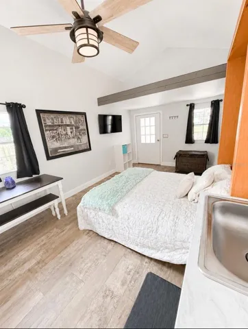 Tiny House front entrance with loft storage area.  Murphy Bed closes up leaving a nice living space.