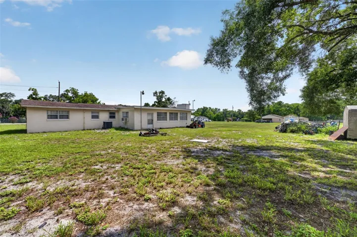 Open rear/side yard — cleared area available for subdivision.