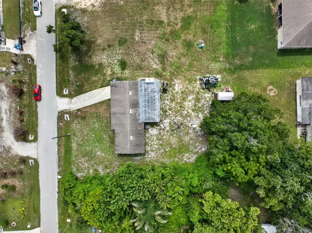 Close aerial view of the property and adjacent street.