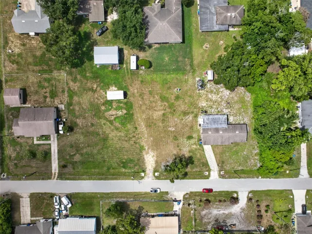 Aerial view with parcel boundary — 1.03 acres, up to 6 buildable 50'x150' lots.