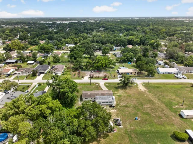 Wide aerial view of the neighborhood surrounding the property.