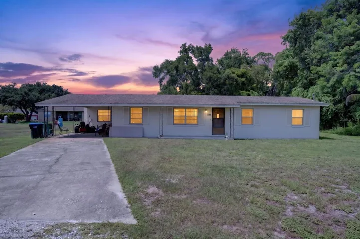 Twilight elevation of the existing 3BR/1BA home on the 1.03-acre site.