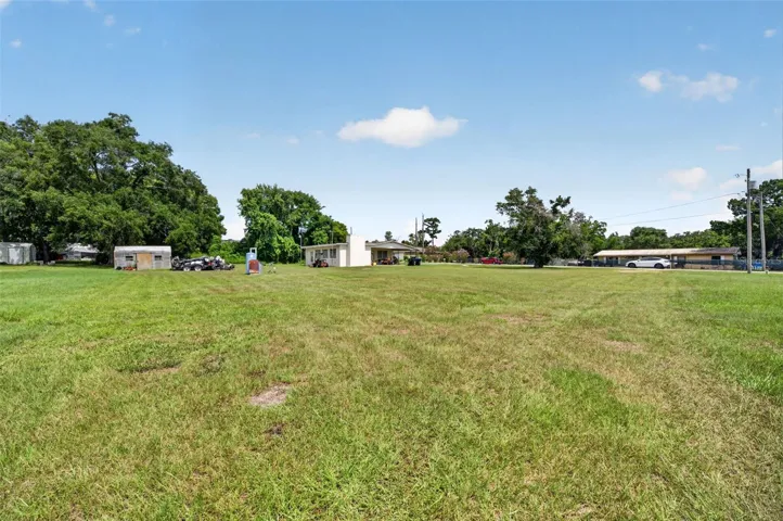 Yard view toward neighboring parcels — context for assemblage.