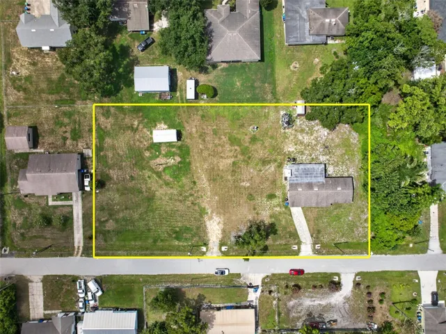 Aerial view with parcel boundary — 1.03 acres, up to 6 buildable 50'x150' lots.