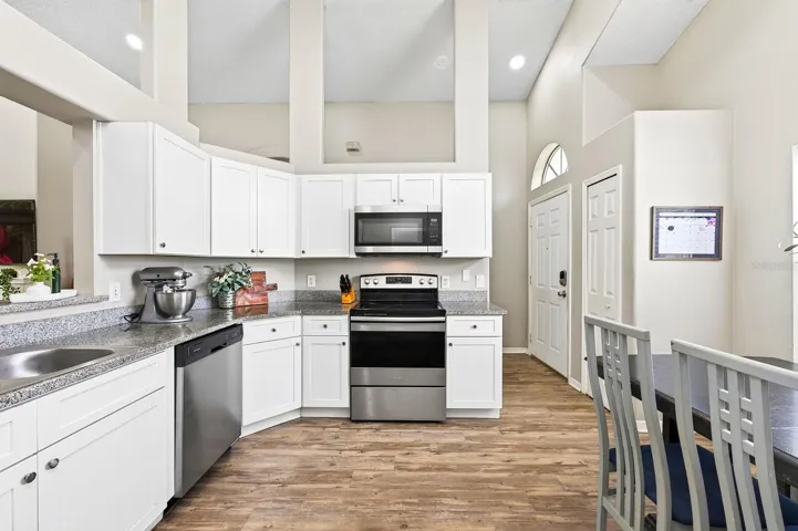 The EAT-IN KITCHEN is designed for everyday living with STAINLESS STEEL APPLIANCES, pantry storage, a neutral color palette, abundant NATURAL LIGHT, and a convenient pass-through to the living area to keep everyone connected.