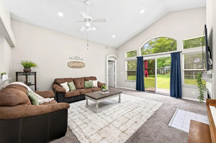 Spacious living room with sliding glass doors that open to your expansive fully fenced backyard.
