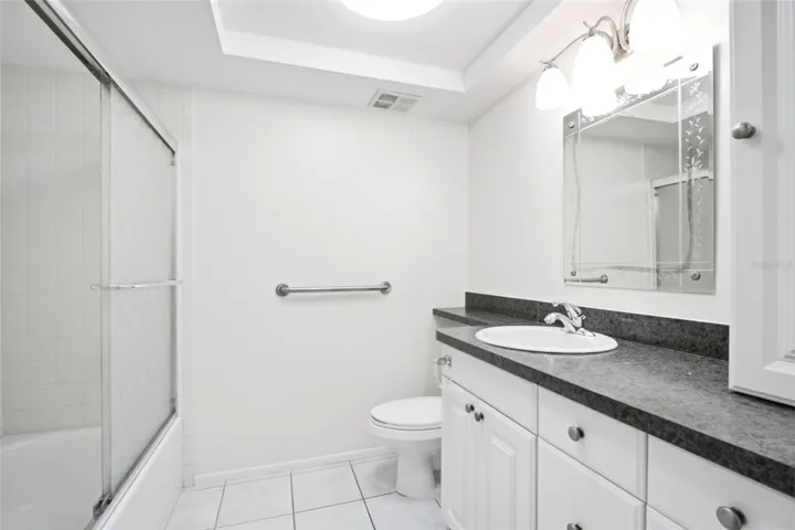 Updated hall bath conveniently located between the main living & guest suite~