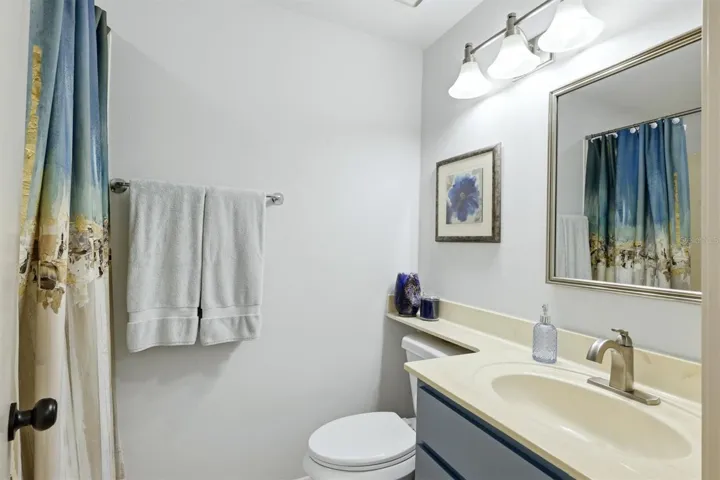 water closet in primary bathroom with jetted tub and shower combination
