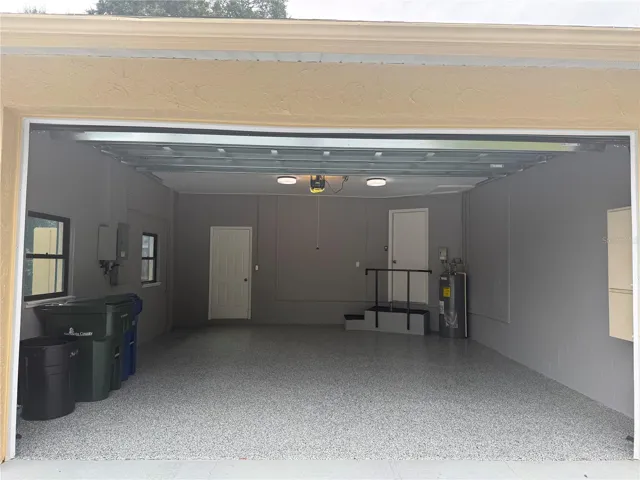 Two car garage with door to golf cart garage