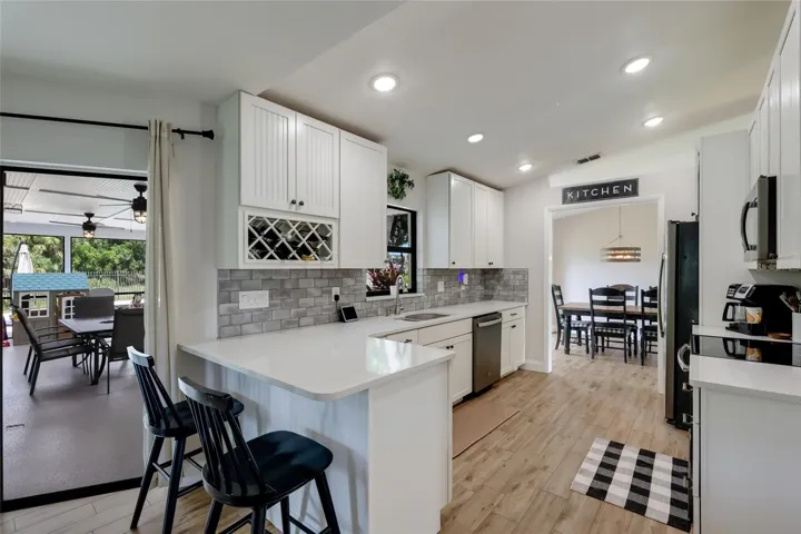 Custom 42 inch soft-close bead board cabinets and quartz countertops