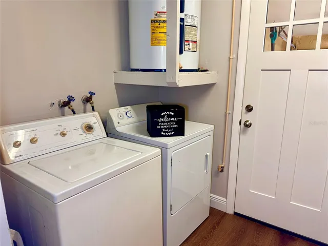 Laundry room with lots of additional storage shelving on back wall.