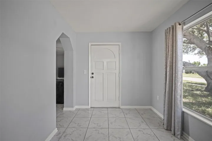 Second view of entry room with front door