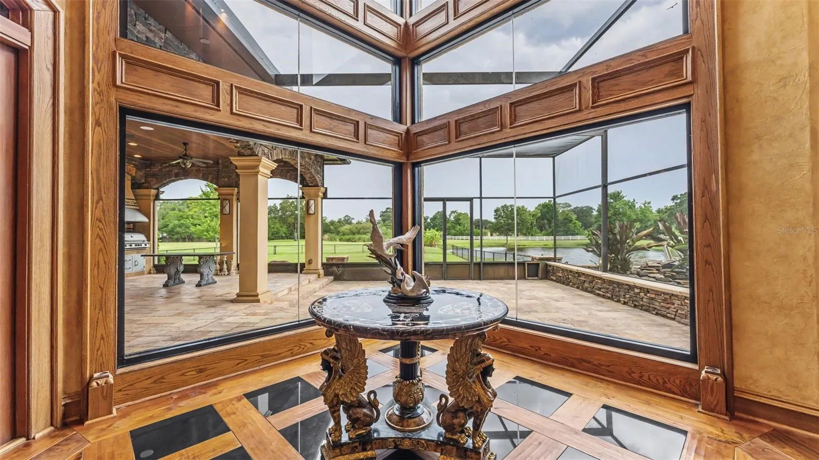 Framed with custom millwork this 30 foot Wall of Tinted Impact Glass -seamlessly blends the indoor luxury with the breathtaking views.