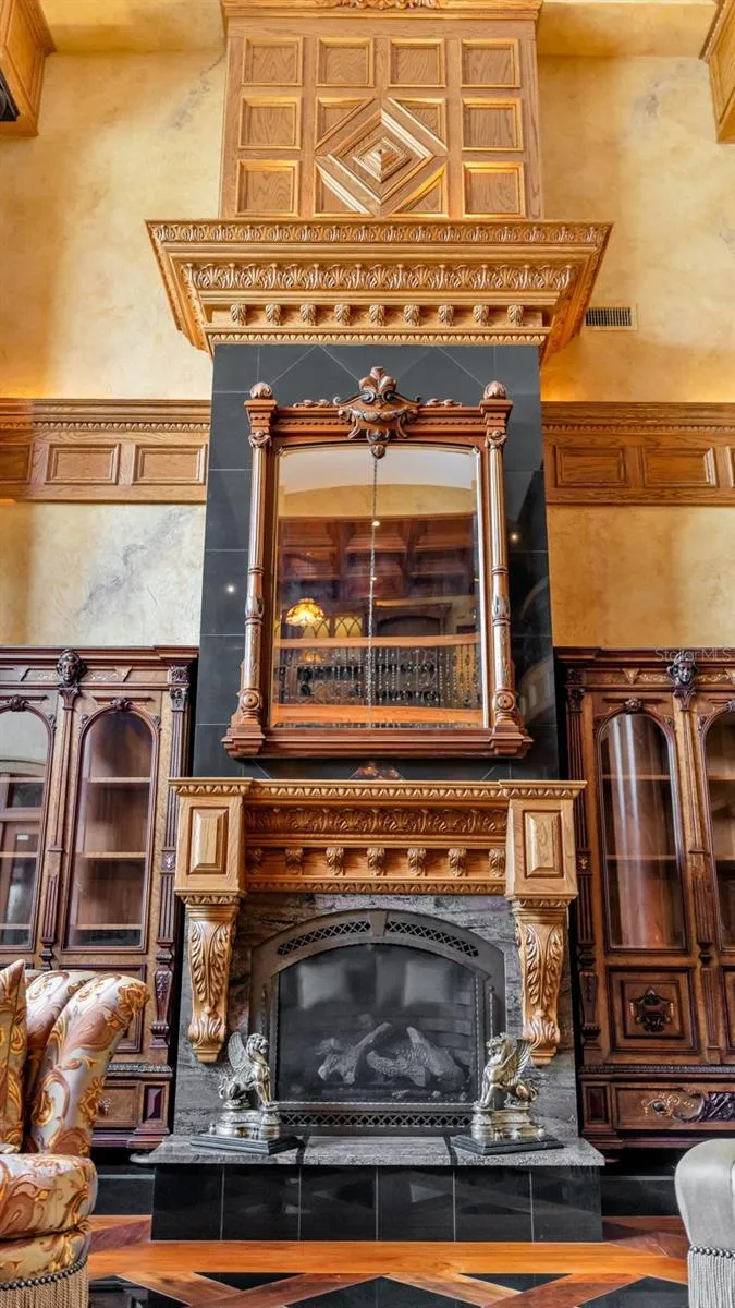 Intricate millwork crowns this Expansive Marble and Oak Fireplace