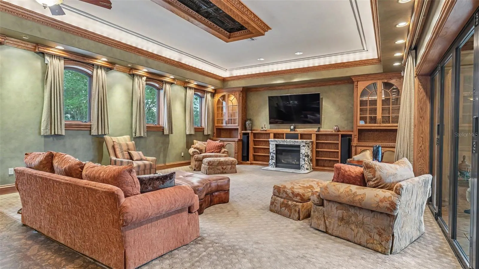 A Massive Family room offers ample seating for Family or Holiday Events. Elevated Windows allow light to flutter in and out of the French doors leading to the Lanai.
