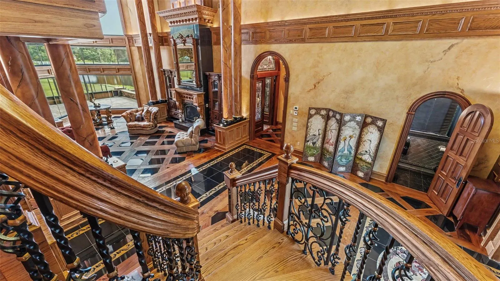 Hand Carved and Master crafted Oak  & Rod Iron Handrail on this superb oak and Marble Staircase. This is an example of why it took 5 years to custom build this home!!
