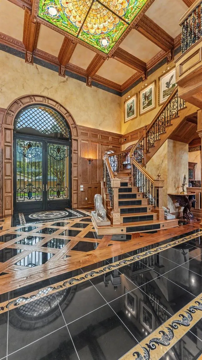 Foyer-Shows off the Oak & Marble steps of the Stairwell