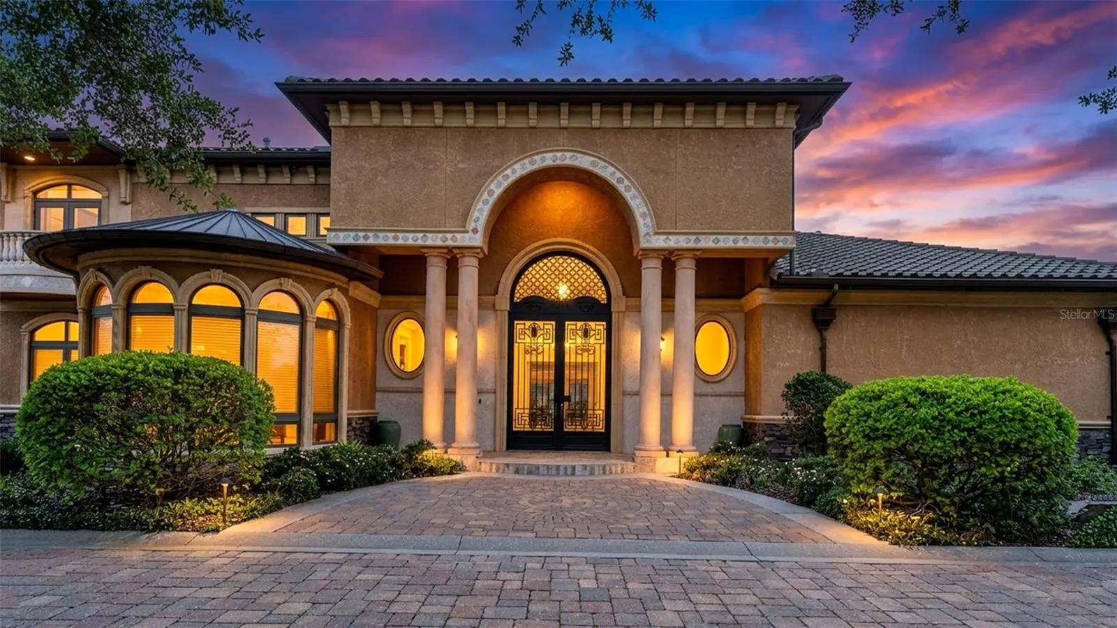 Welcome Home! A 10 foot tall Arched Glass & Iron doorway greets you. The symmetry of the arched windows and doors are truly a Majestic theme that continues throughout this Superb Equestrian Estate!