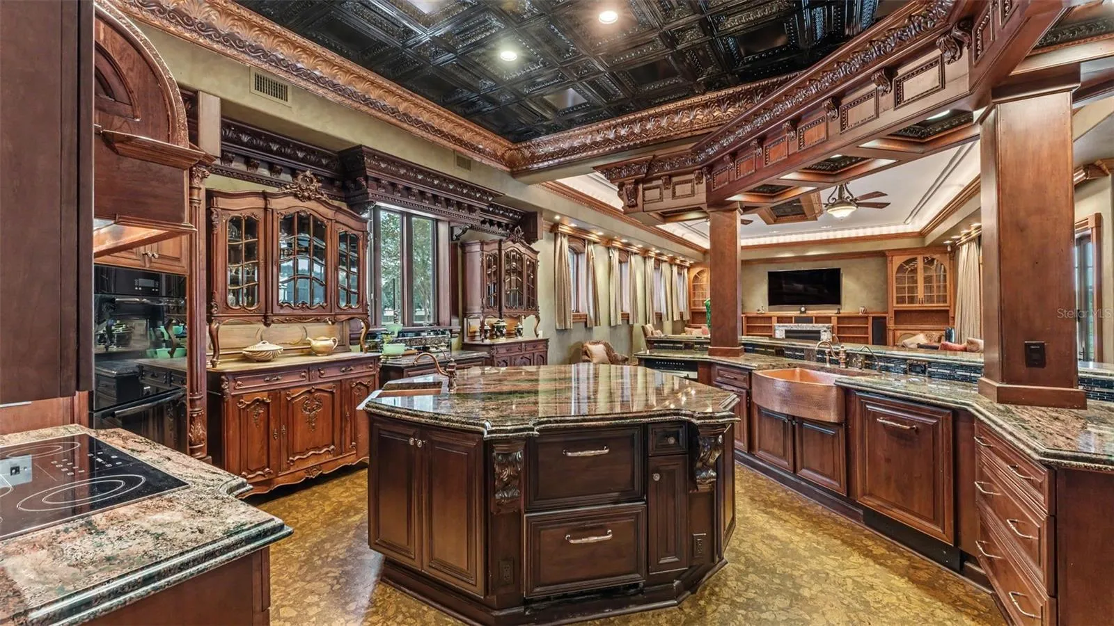 Massive Gourmet kitchen offers continuous Rare, Exotic Granite fabricated with a magnificent Stacked Ogee Edge , Solid wood cabinetry, Built in Wood paneled Miele Appliances, Heritage Grade Millwork.