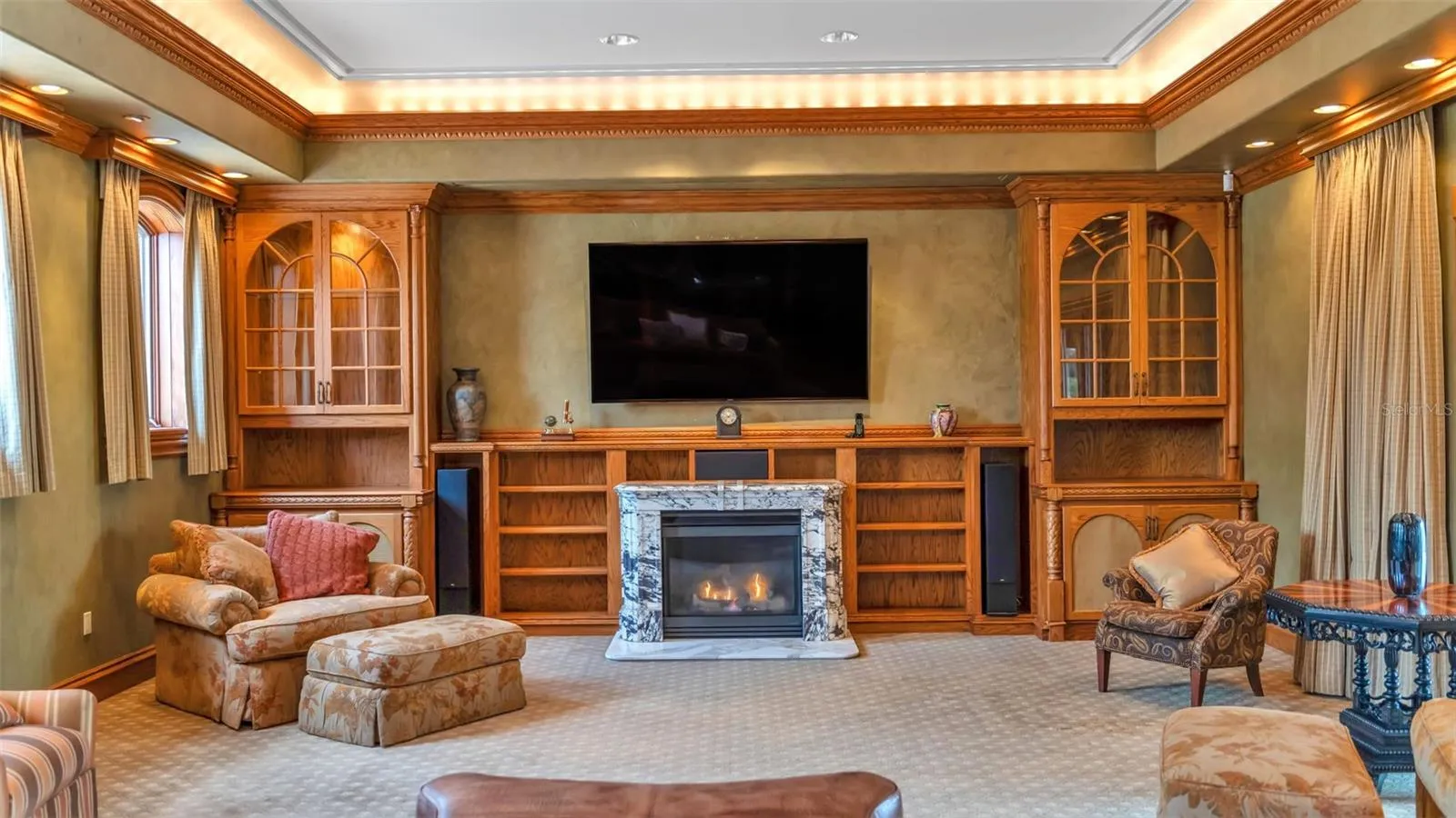 Built-in shelving, surround sound & lighting features as well as the remote controlled window treatments are all features of this spacious Family room.