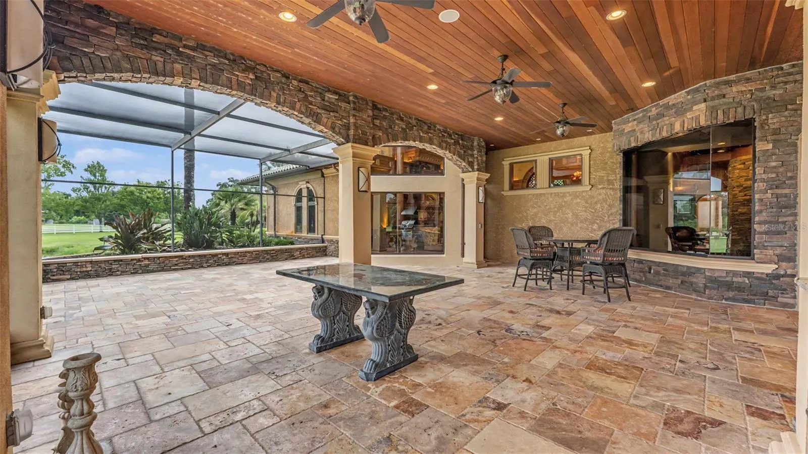 Travertine pavers add timeless beauty and function to this Outdoor Space.