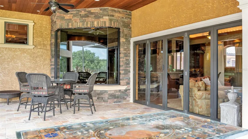 Accordion Styled Glass Doors fold back in a graceful sweep transforming the living space for entertaining.