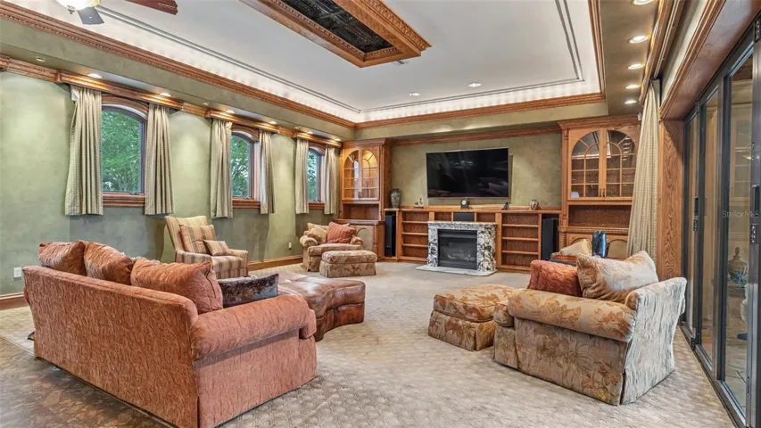 A Massive Family room offers ample seating for Family or Holiday Events. Elevated Windows allow light to flutter in and out of the French doors leading to the Lanai.