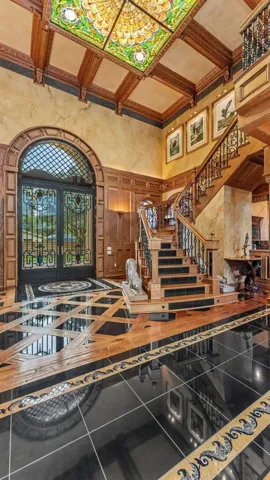 Foyer-Shows off the Oak & Marble steps of the Stairwell