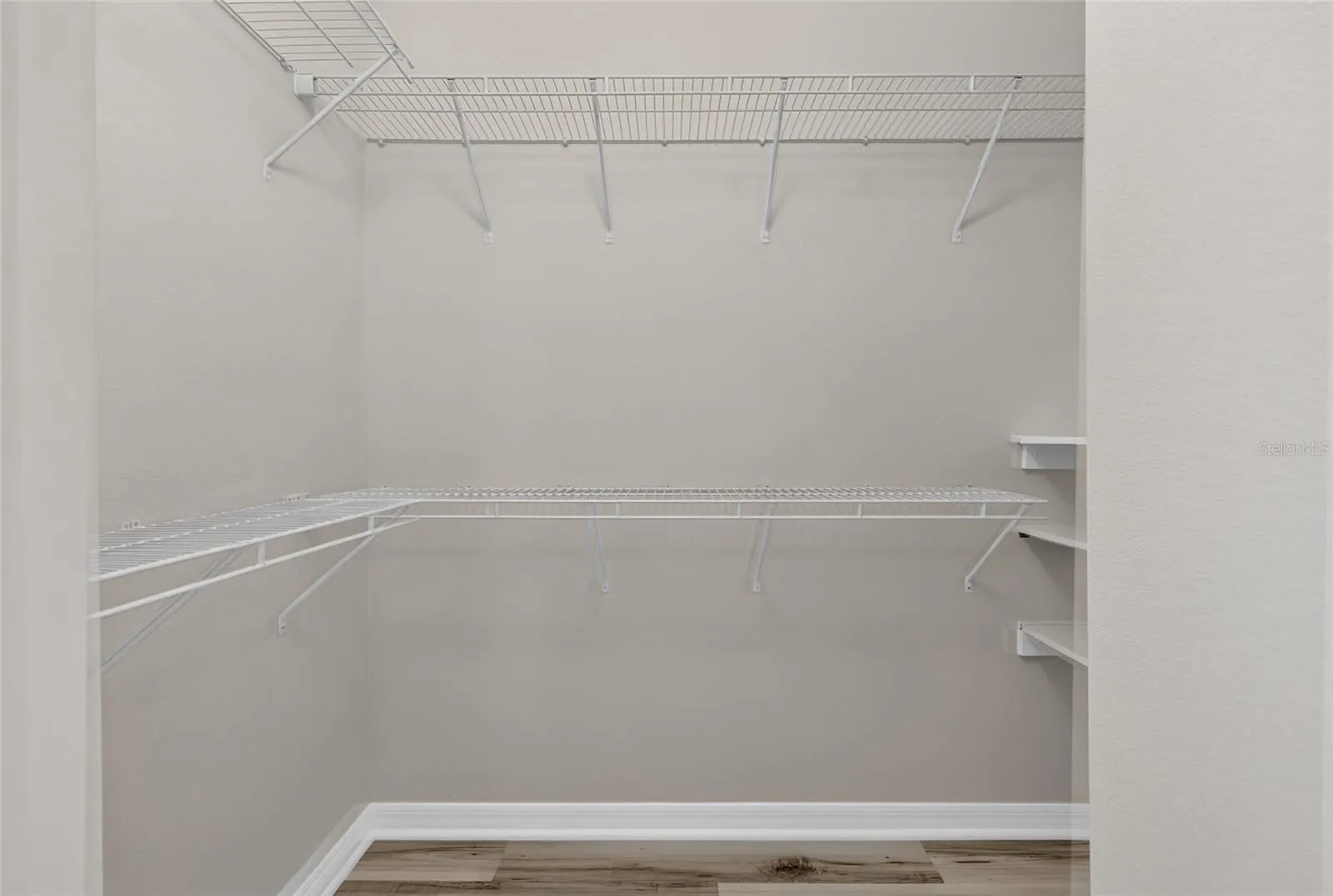 1 of 2 primary bedroom walk in closets