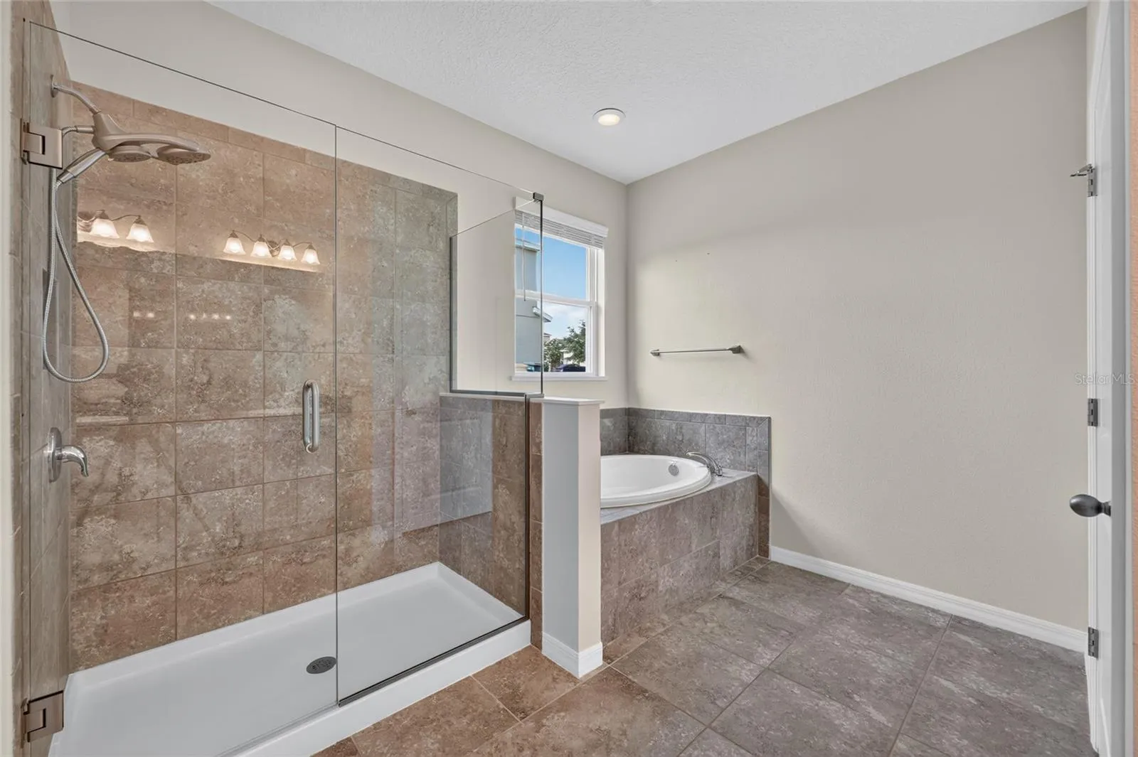 Primary bathroom with walk in shower and garden tub