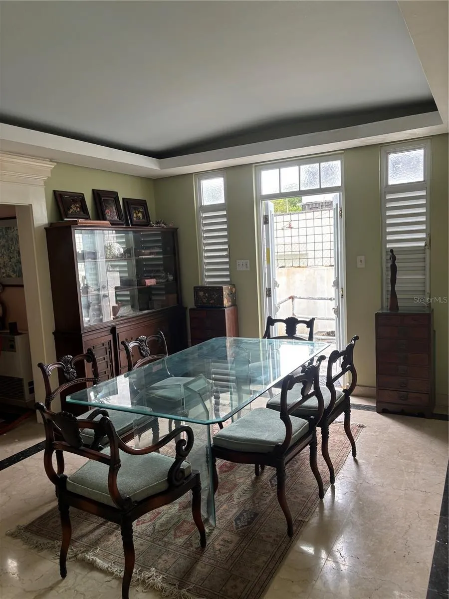 Formal Dining Room with doors to the back yard gardens.