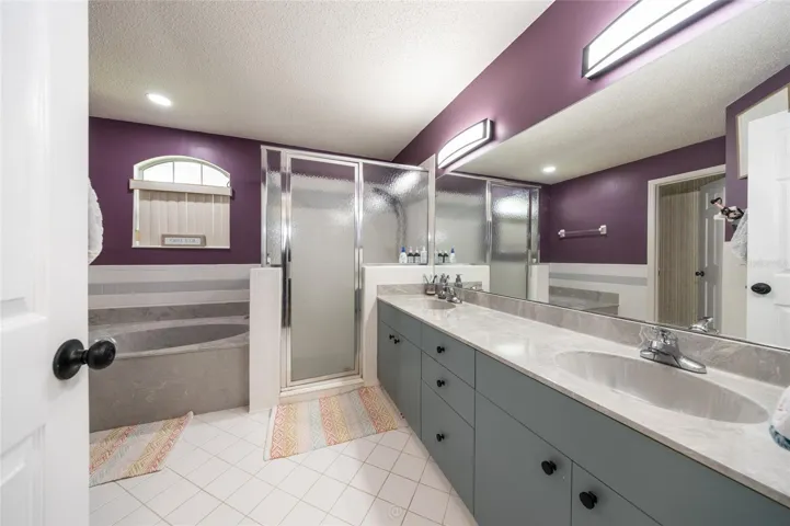 Owners suite bathroom with tub and shower