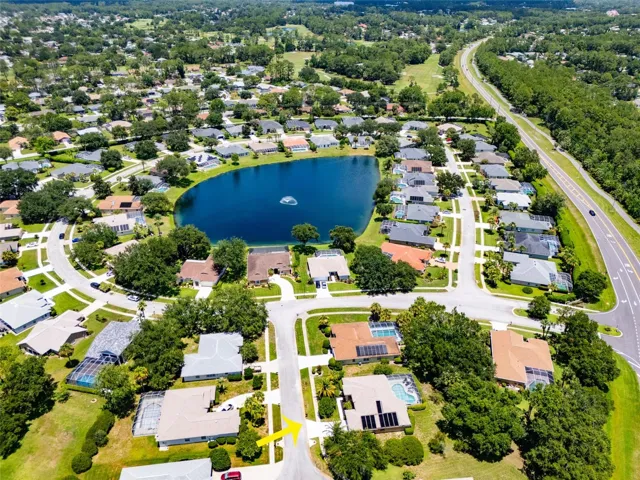 Aerial view of community with lake