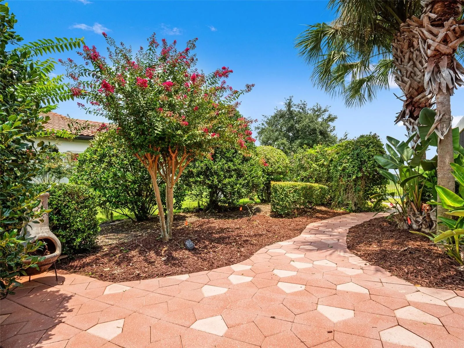 Meandering brick path around side of house