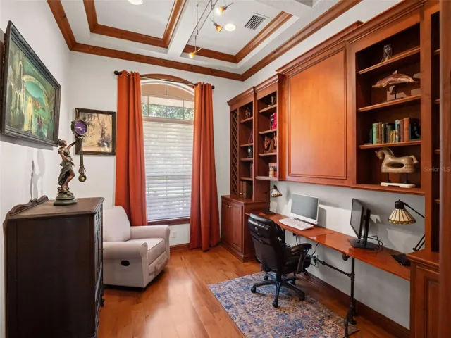 Office with beautiful floor to ceiling built-ins and matching crown molding